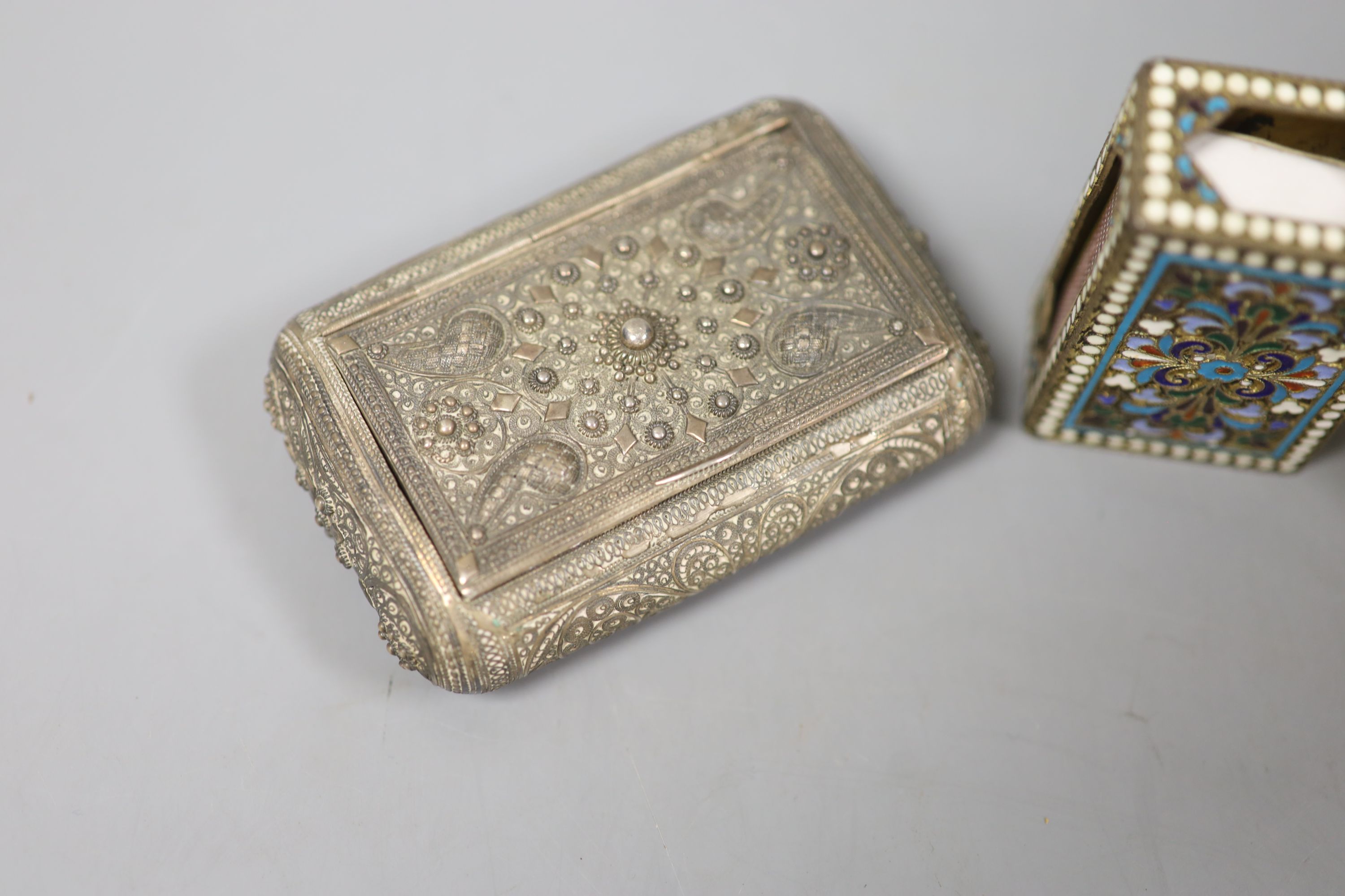 A filigree white metal cigarette box, an enamelled matchbox holder and a white metal mustard pot.